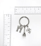 Paris France themed keychain. Includes Eiffel Tower, Arc de Triomphe, and Fleur de Lis. Gift for French lover.
