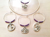 Yoga Wine Charms: Yoga Themed Wine Charms. Perfect gift for the Yogi in your life. Includes Om, Lotus Flower, Namaste, Tree Pose. Set of 4.