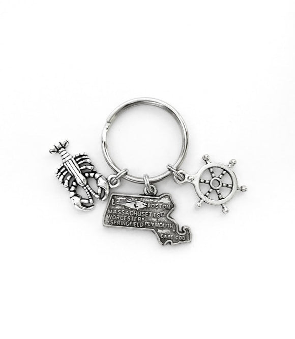 Massachusetts themed keychain. Includes State of Massachusetts, a Lobster, and Ship Wheel Charms. Boston Lover Gift.