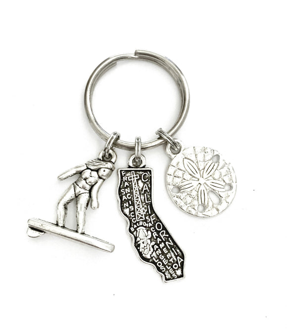 California Beach themed keychain. Includes State of California, Sand Dollar, and Surfer.