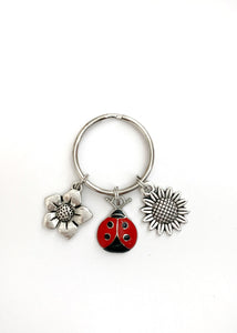 Ladybug and Flower themed keychain. Gift for ladybug Lovers, Bag and Key Identifier. Includes Ladybug and Two Flower Charms.